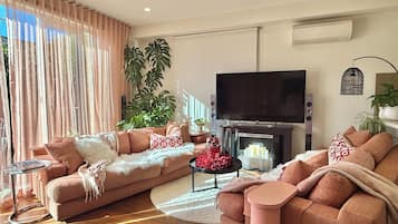 Smart TV, fireplace, books, printers