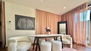 A modern living room with a round table, white armchairs, and a red patterned rug. - Soft Modern Glamour in the Heart of Camberwell (Camberwell)