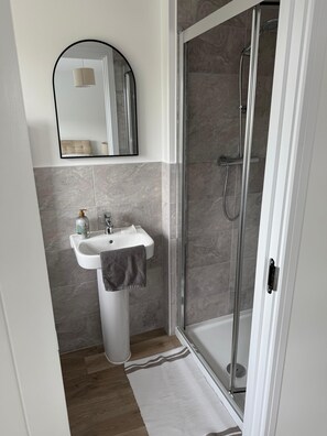 Shower, hair dryer, towels, toilet paper