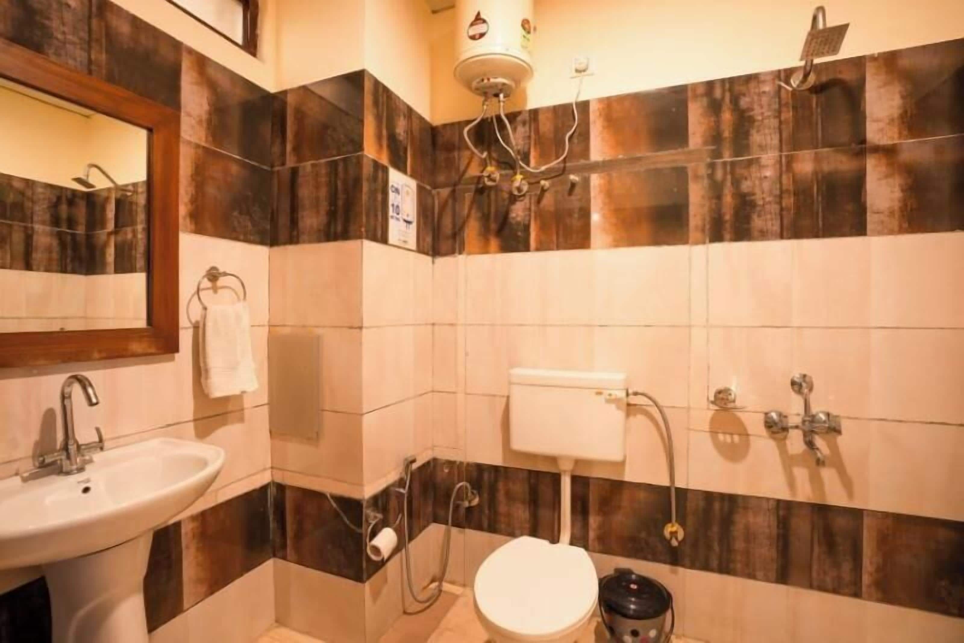 A bathroom with a sink, toilet, and shower.