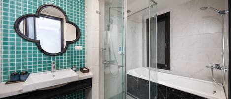 A modern bathroom with a glass-enclosed shower, a white sink, and a large mirror.