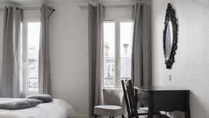 A bedroom with a bed, a chair, a desk, and a mirror. - Europe BLV (Paris)