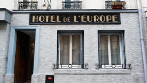 A building with a sign reading "HOTEL DE L'EUROPE" and a door leading into the building. - Europe BLV (Paris)