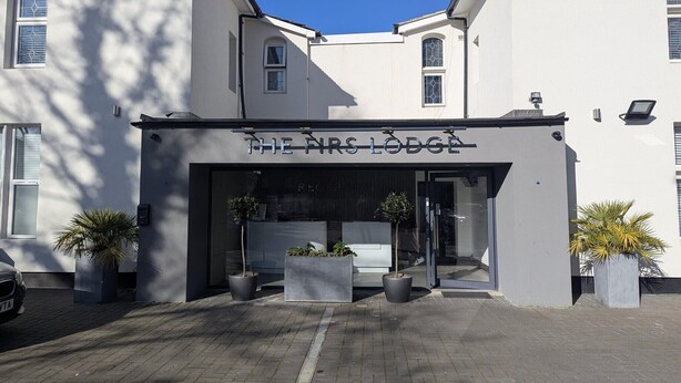 A building with a sign reading "THE NRS LODGE". - OYO Firs Lodge London Heathrow| Standard Double (Hounslow)