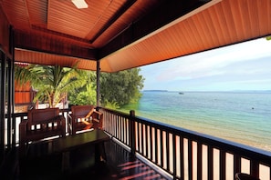 A wooden deck with a view of the sea and a distant island. - PS Bunaken Resort & Dive (Pulau Bunaken)