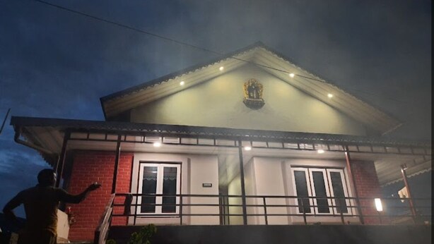 A two-story building with a gabled roof and a central decorative element. - Manjushree Homestay (Darjeeling)