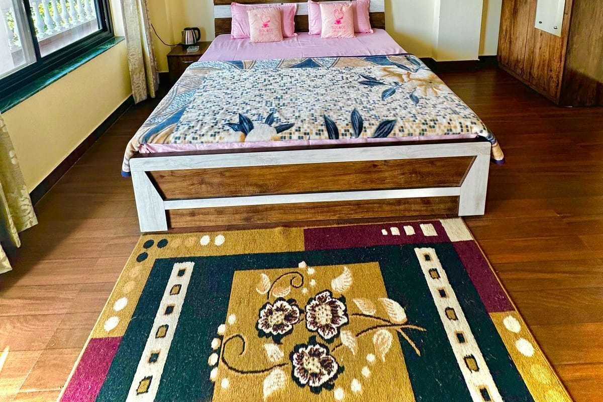 Un dormitorio con cama, ventilador de techo, ventana y puerta.