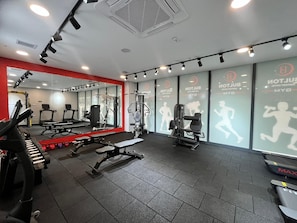A gym with exercise equipment, mirrors, and motivational posters on the walls. - Bulton Hotel Airport (Arnavutköy)