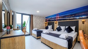 A hotel room with two beds, a desk, and a large window with a cityscape view. - Bulton Hotel Airport (Arnavutköy)