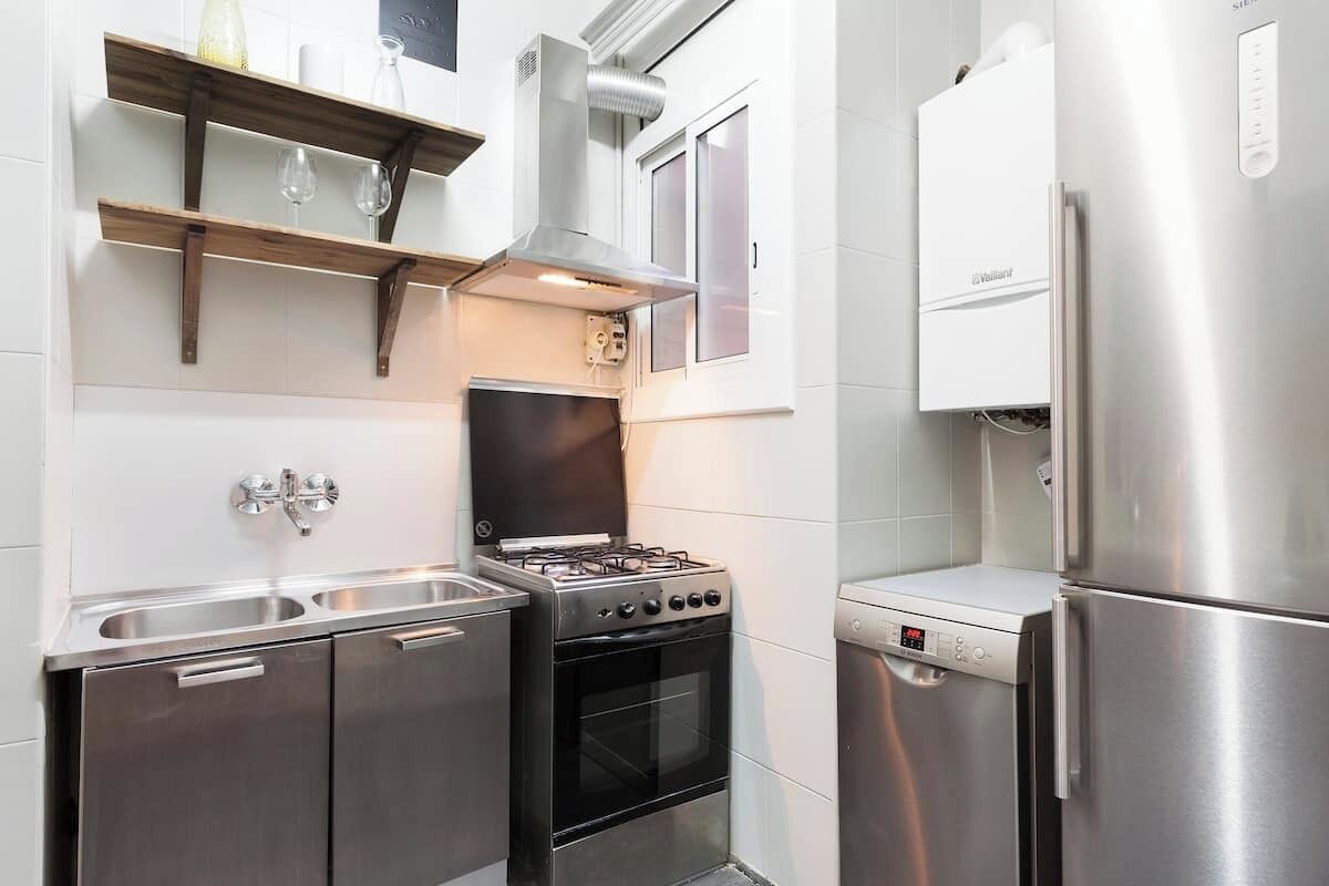 A modern kitchen with stainless steel appliances, including a gas stove, oven, and refrigerator.