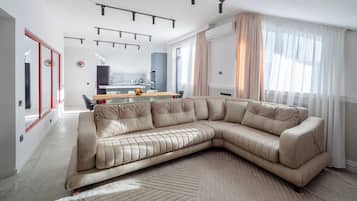 Family Apartment, Balcony, City View | Living area | Flat-screen TV