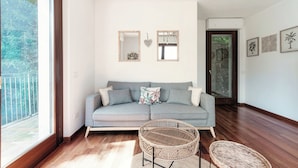 A modern living room with a grey sofa, two mirrors, and a wicker chair. - Sky Attic Lake Como (Como)