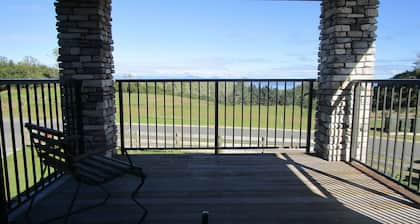 Apartment with lake, mountain & rural views.
