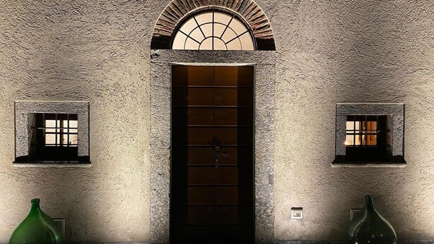 A textured stone wall with a central door and two small windows. - 1 bedroom private vacation home in canzo (Canzo)