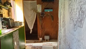 Una cocina con piso a cuadros, una encimera con varios objetos y un paño colgado.