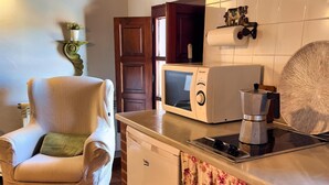 A compact kitchen with a microwave, toaster, and coffee maker. A small refrigerator is also visible. - 2 bedroom apartment in the historic center of Isla, close to the beach. (Isla)