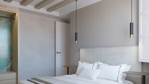Una camera da letto moderna con un letto grande, comodini e lampade a sospensione.