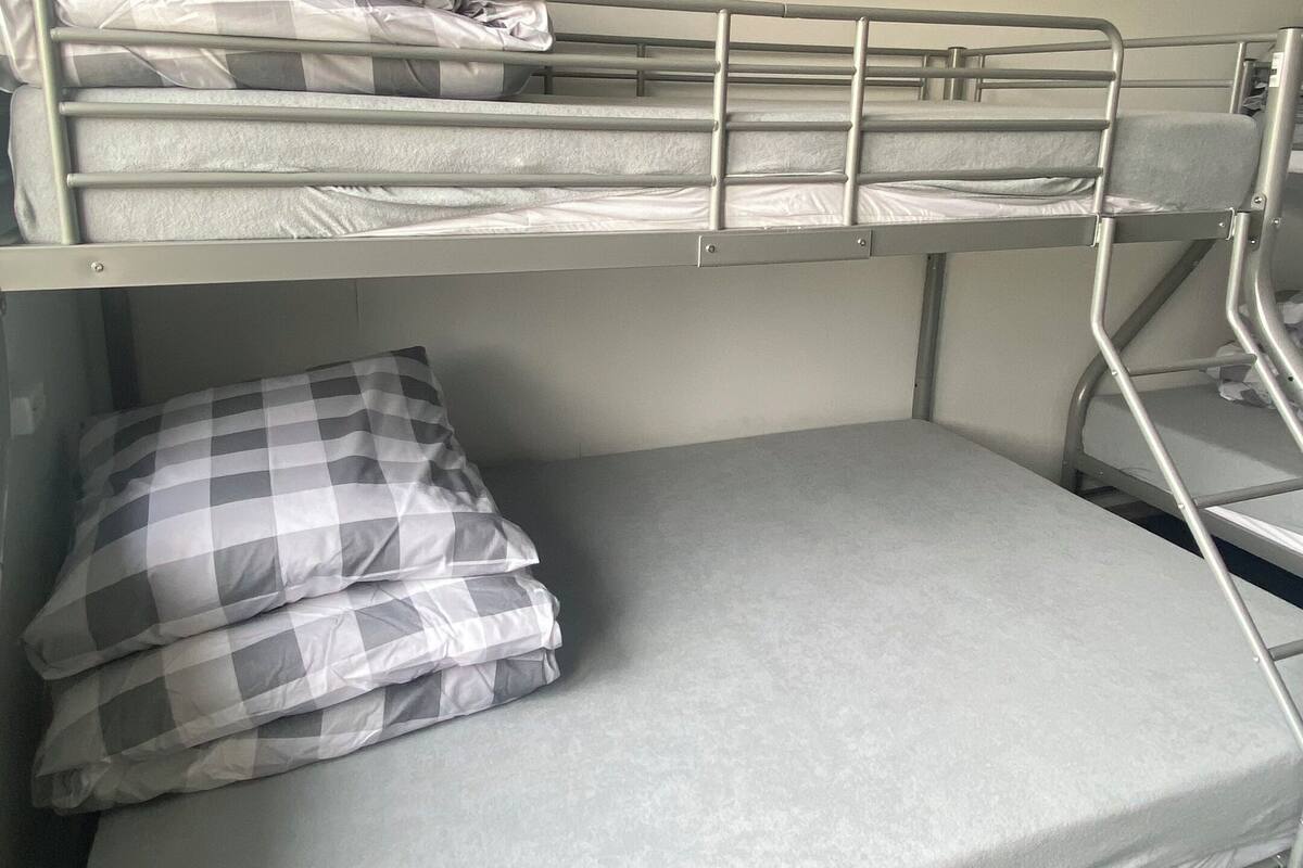 A bunk bed with a mattress and pillows.