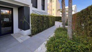 A modern building with a clean facade, a well-maintained hedge, and a pathway leading to the entrance. - 2 bedroom apartment in torrox costa (Torrox Costa)