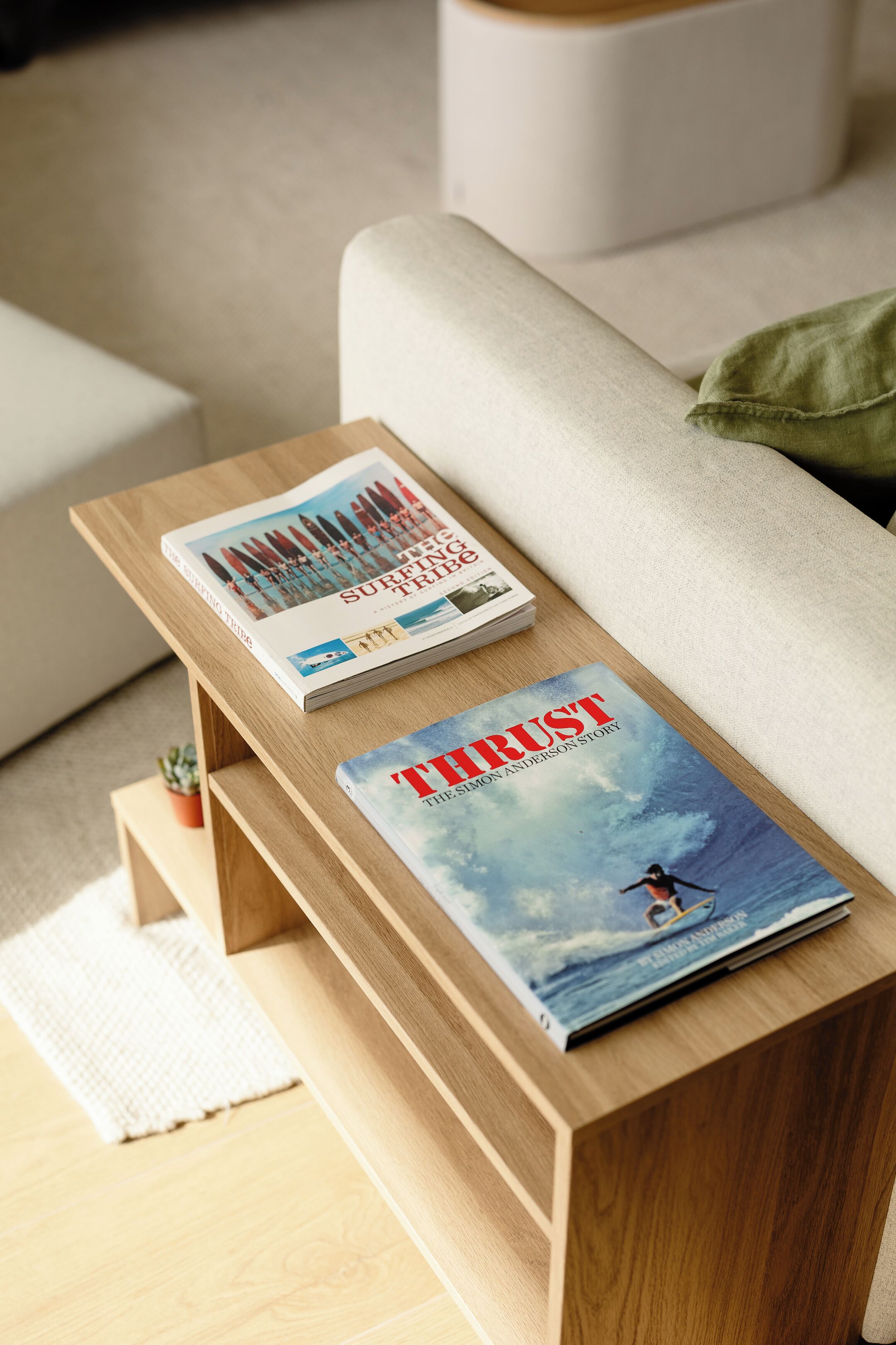 Ein Holztisch mit einem Magazin mit dem Titel 'THRUST' und einem weiteren Magazin darauf.