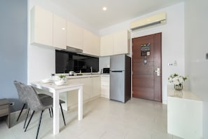 Enjoy meals in the kitchen with an oven, stainless steel refrigerator, and dining area with a table and chairs.
