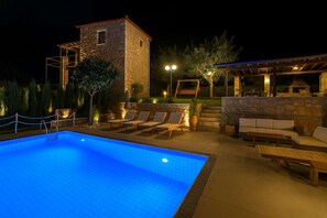A swimming pool with lounge chairs and a barbecue area. - Villavia Residence - Sorocco Villa (West Mani)