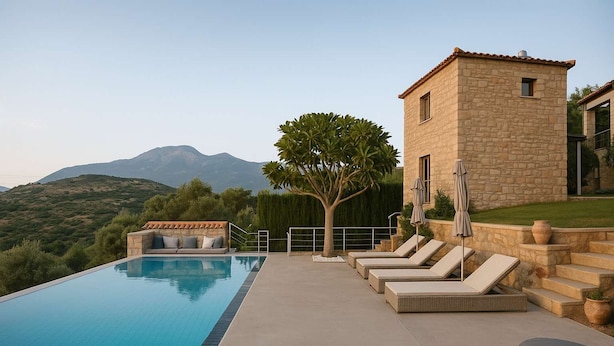 A swimming pool with lounge chairs and a stone building. - Villavia Residence - Sorocco Villa (West Mani)