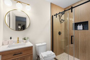 Shower, hair dryer, towels, shampoo