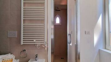 Ein modernes Badezimmer mit integriertem Bidet, Handtuchhalter und Duschbereich.