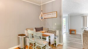 A dining area with a table, chairs, and a hanging light fixture. - Private Dock: Pet-friendly Home on Lake Sinclair (Milledgeville)