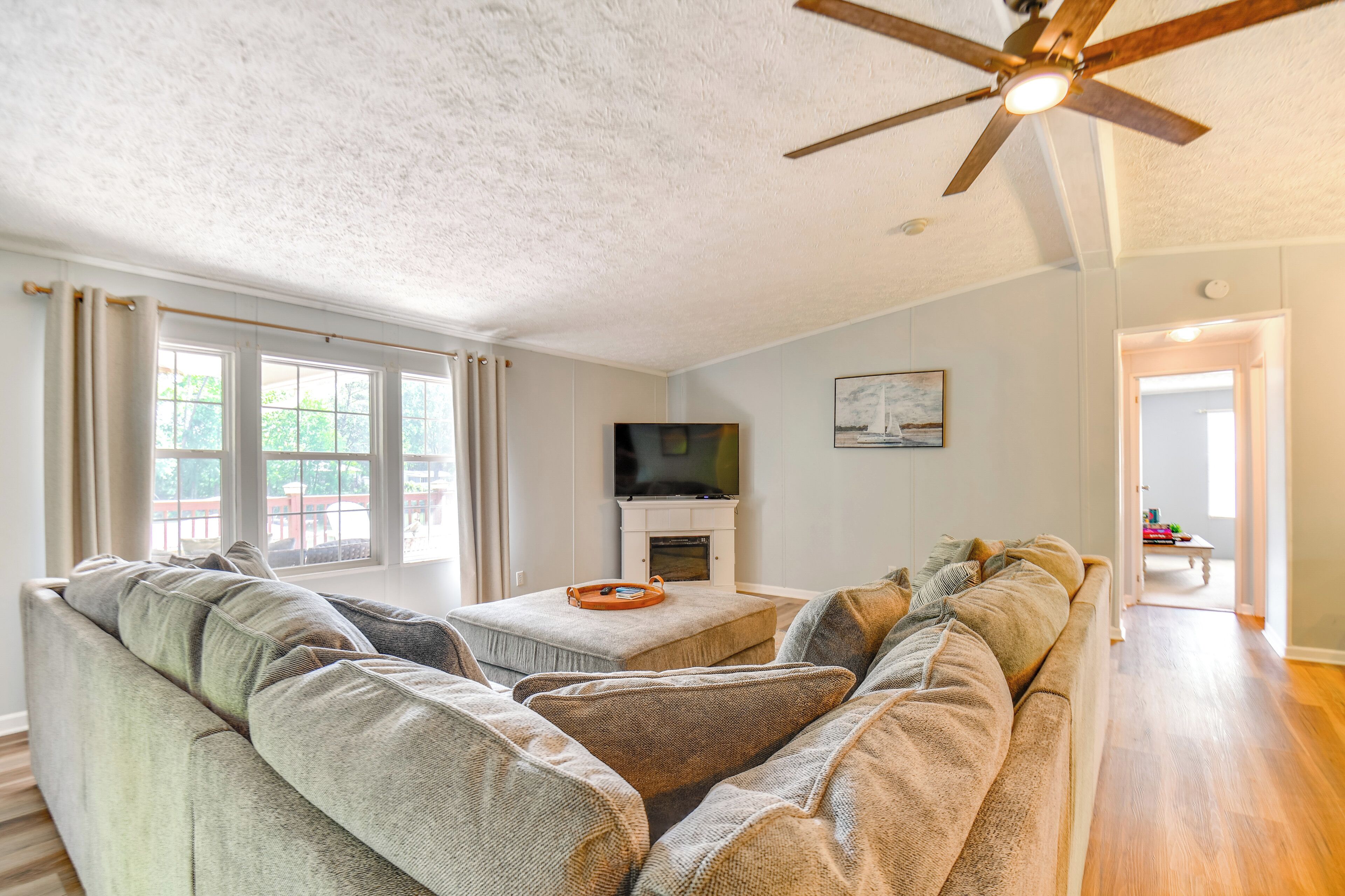 A living room with a sofa set, a television, and a fireplace.