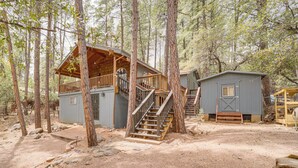A cabin with a wooden deck, a staircase, and a small shed. - Near Fossil Creek & Trails: Scenic Pine Cabin! (Pine)