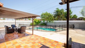 A patio with a pool, outdoor furniture, and a covered seating area. - Sunny Spanish Villa Pool Parking Privacy (Hacienda Heights)