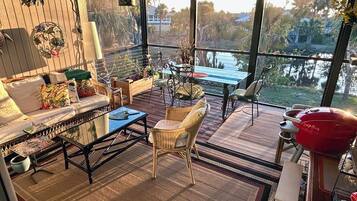 Relax in this well-appointed outdoor space with a sofa, chairs, and dining table, perfect for al fresco dining and socializing.