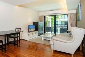 Family Condo, 1 Bedroom, Balcony, Garden View | Living area | 36-inch flat-screen TV with cable channels