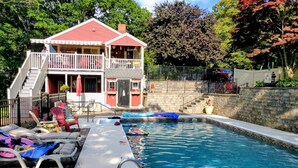 A two-story house with a swimming pool, a covered patio, and a fenced yard. - Coastal Comfort With Stunning Harbor Views 3 Bedroom Home (Plymouth)