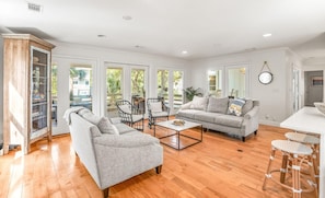 Relax in this stylish living room with a large sofa, two armchairs, and a coffee table.