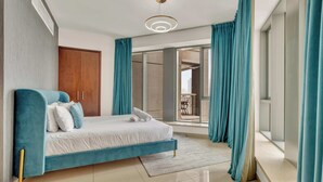 A modern bedroom with a large bed, teal curtains, and a view to the outside. - Bellavista-1BR-Full BurjKhalifa&Fountain (Dubai)