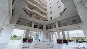 A multi-level atrium with balconies, large windows, and a central open space.