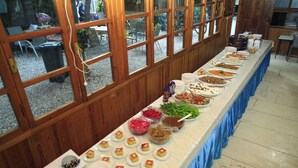 A buffet table with various food items and dishes. - Korsan Pansiyon (Kumluca)