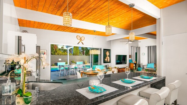 A modern kitchen with a large island, wooden ceiling, and pendant lighting. - 30+ Stay! W/Pool, Hot Tub, Large Patio, Ping Pong (Palm Springs)