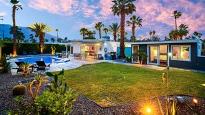 A modern house with a swimming pool, outdoor seating, and palm trees. - 30+ Stay! W/Pool, Hot Tub, Large Patio, Ping Pong (Palm Springs)