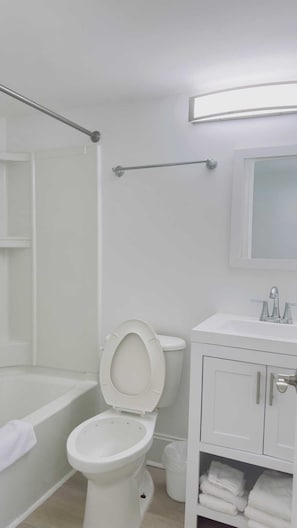 A bathroom with a toilet, sink, and bathtub. - Boutique on the beach, Studio #106 + Pool (Myrtle Beach)