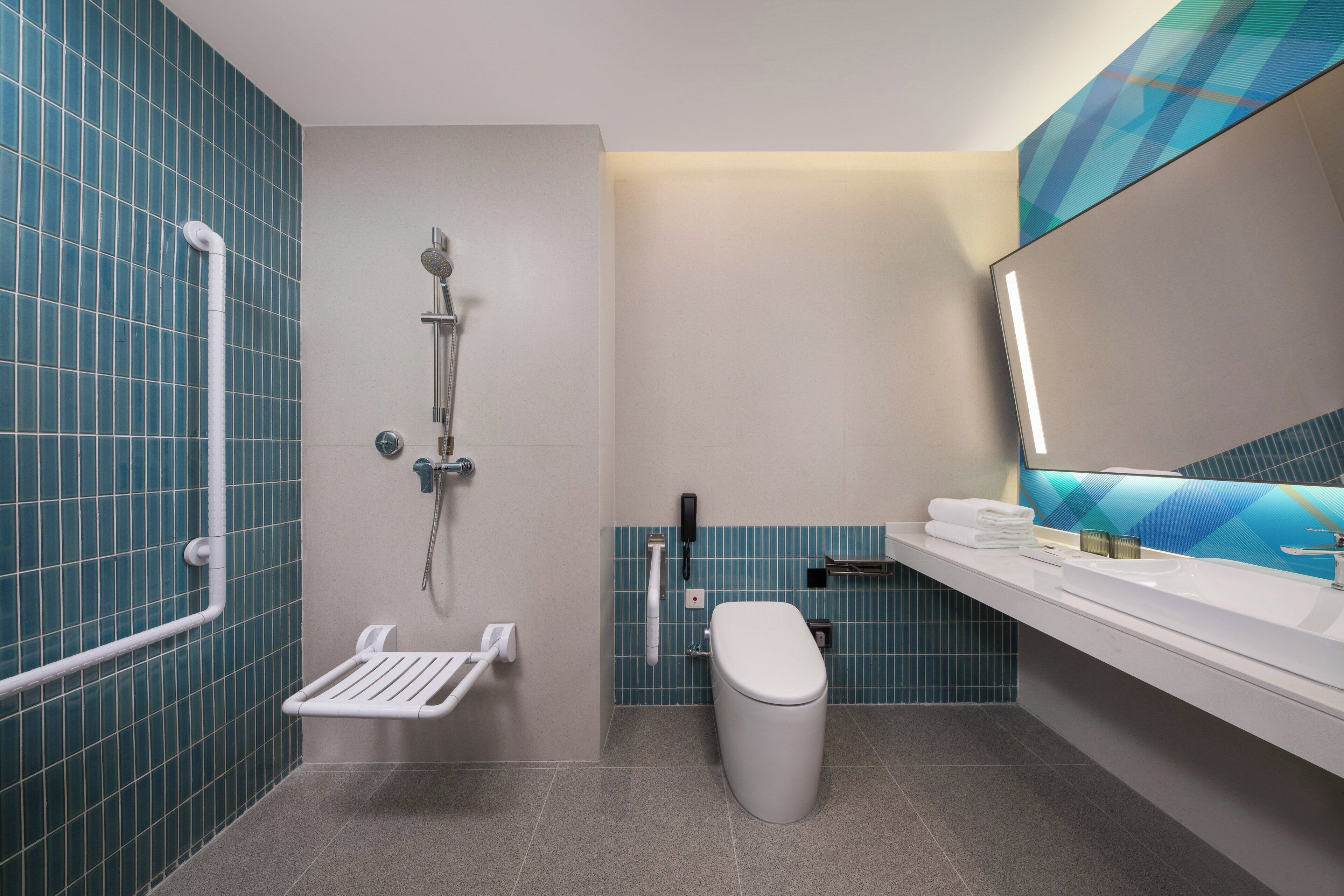 A modern bathroom with a shower, toilet, and sink.
