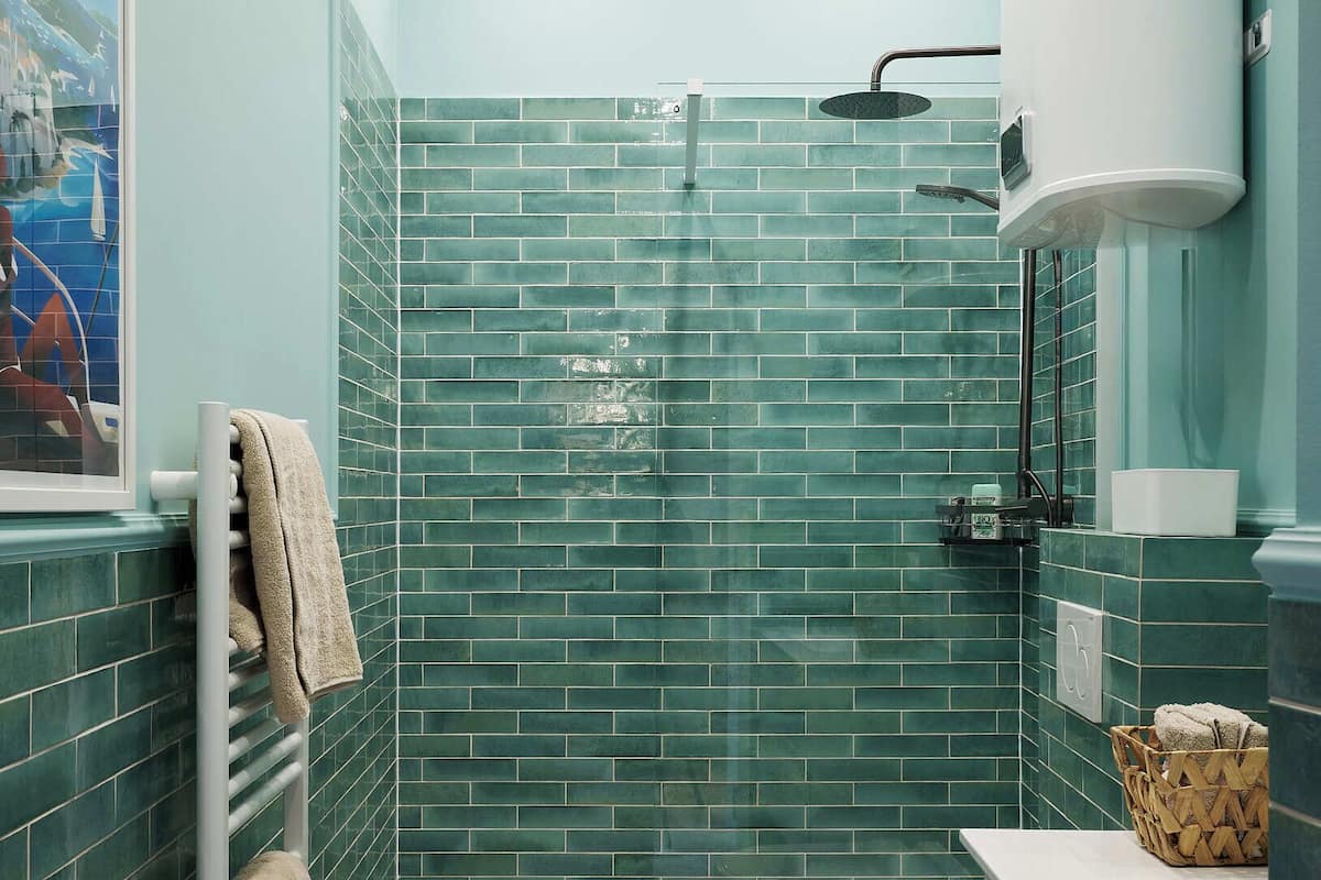 Une salle de bain avec une douche, des toilettes et un porte-serviettes.