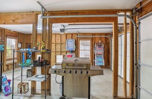 Enjoy outdoor cooking and maintenance activities in this functional space with a central barbecue grill and storage for essentials.