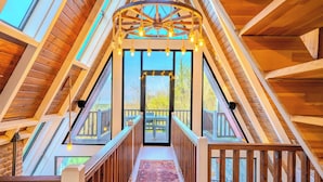 A wooden interior with a central staircase leading to an outdoor deck. - Grand Paradise Resort (Sapanca)