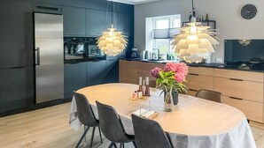 A modern kitchen with a dining area.