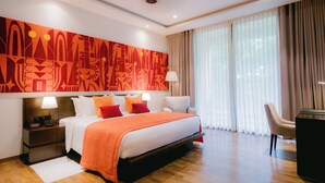 A modern hotel room with a large bed, a desk, and a large window with curtains. - Waters Edge Hotel (Battaramulla)