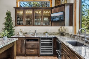 Enjoy cooking in this well-equipped kitchen with a large island, dishwasher, and granite countertop.